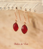 Red quartz dangle earrings in rose gold.