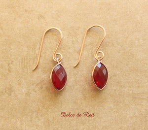 Red quartz dangle earrings in rose gold.